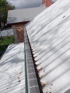 cleaning gutters with gutter guards installed fielders